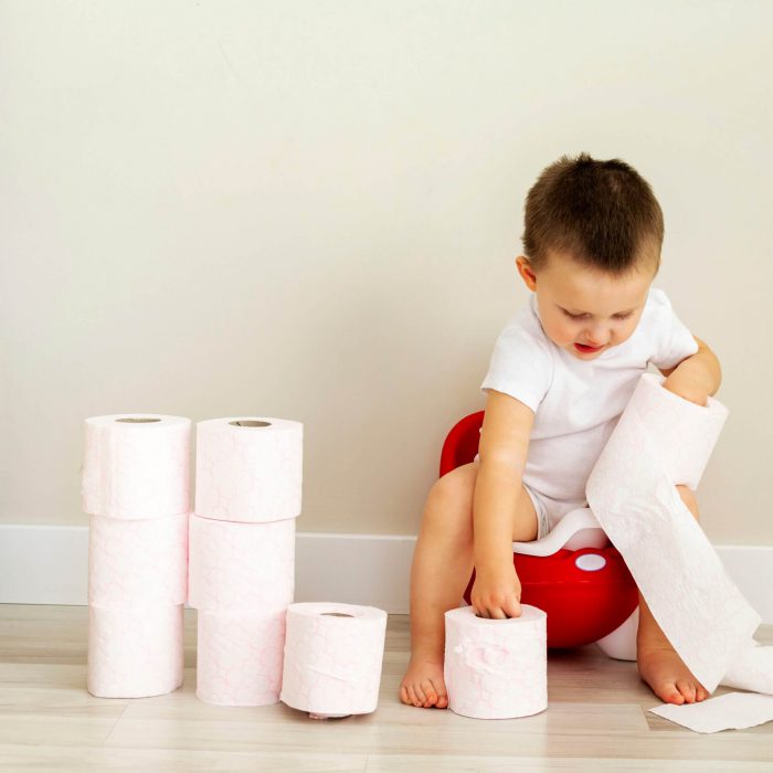 Small,Boy,Toddler,Sitting,On,Red,Potty,And,Playing,With